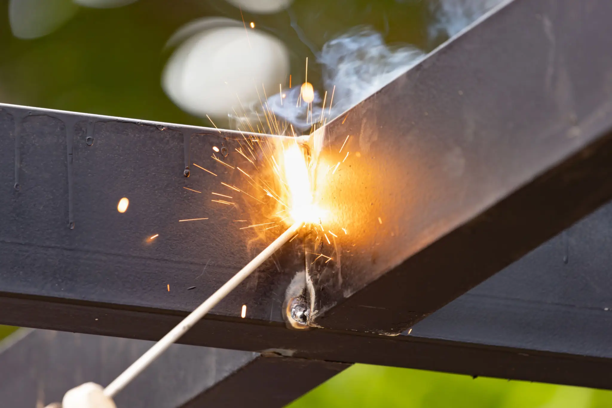 Close-up of welding sparks flying from a metal welding process.